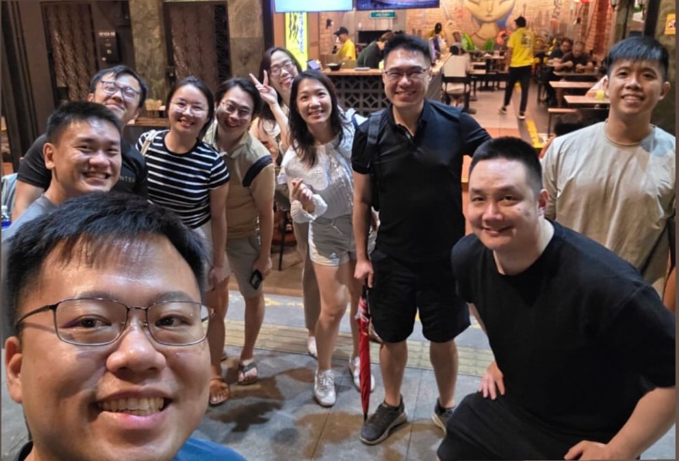Marc Teo with attendees at supper after the first Anti-Hustle, Human-First workshop in Kuala Lumpur.
