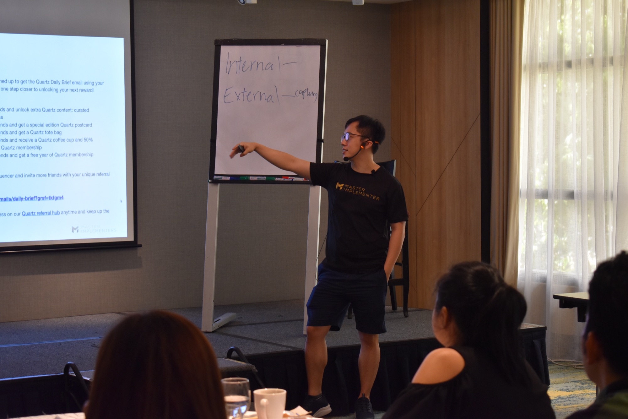 Marc Teo teaching a room of entrepreneurs at a flip chart.